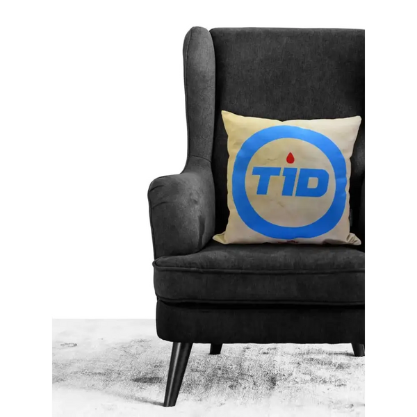 Diabetes Awareness Pillow Cover on dark armchair, blue circle design, supportive home decor.