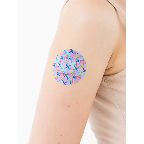 Freestyle Libre 3 adhesive patch in vibrant spring design on arm.
