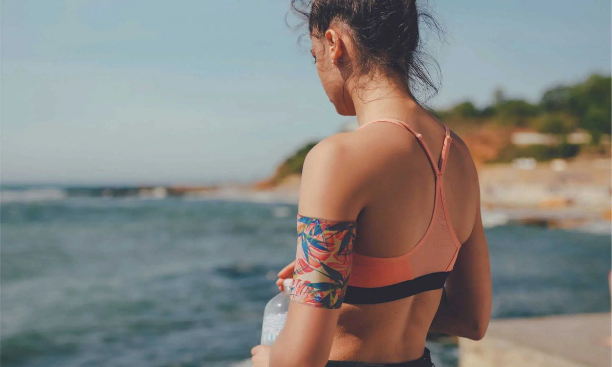 a woman wearing a protective armband for her glucose sensor