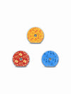 Three Accu-Chek SmartGuide sensor stickers with surfboards, snorkels and seaside illustrations in warm summer colors.