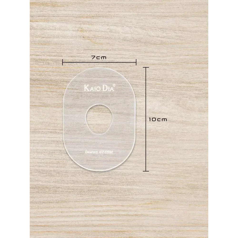 CGM Sensor Patch Template on wooden surface, dimensions 7cm by 10cm, transparent acrylic design.