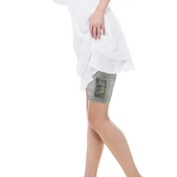 Woman wearing a grey lace garter holding an insulin pump on her thigh under a white dress, lace garter for insulin pump.