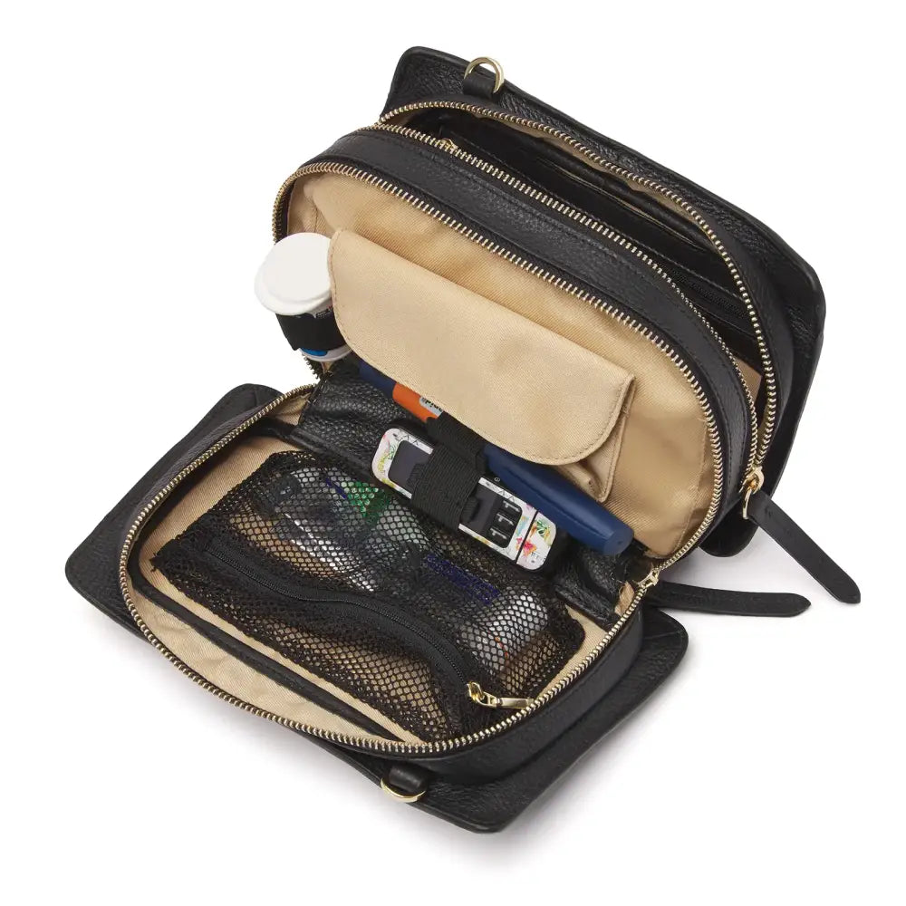 Leather diabetic supplies shoulder bag with multiple compartments and adjustable strap.