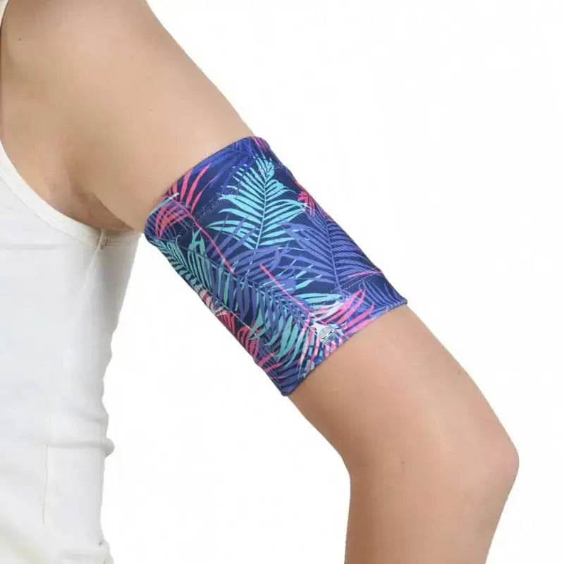 Blood glucose sensor armband with fauna and flora print for secure sensor placement.