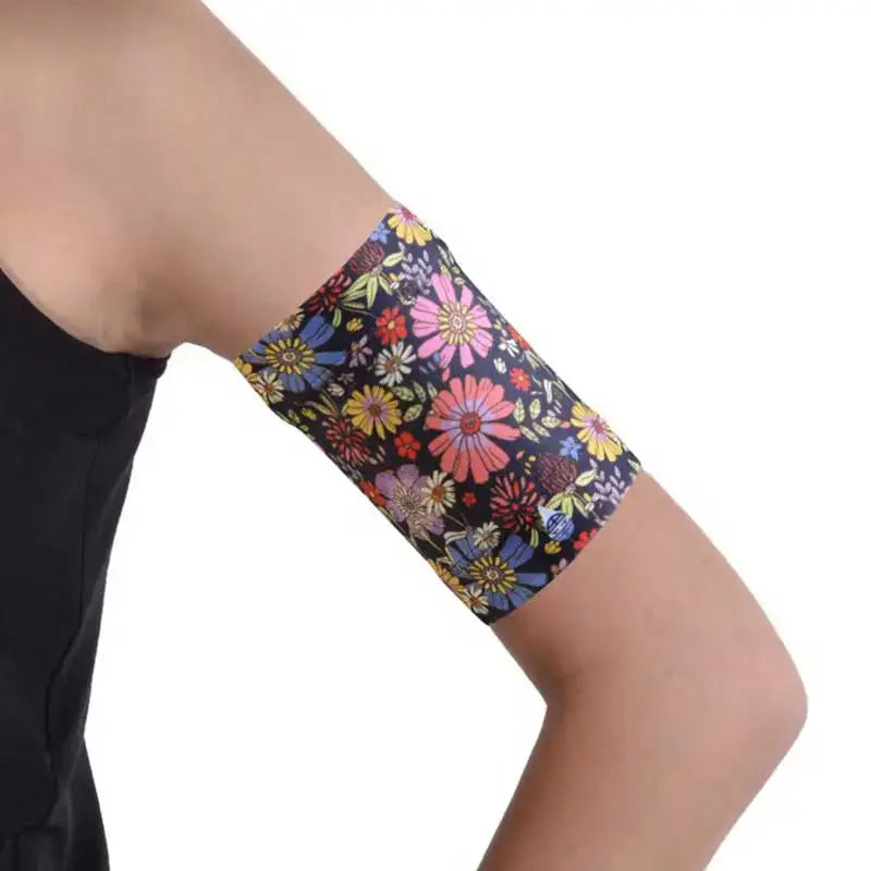Floral print Dia-Band blood glucose sensor armband on arm.