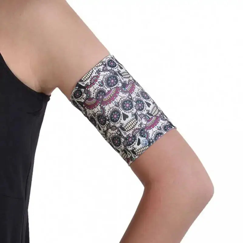 Trendy CGM armband for diabetes with stylish retro print, worn on upper arm.
