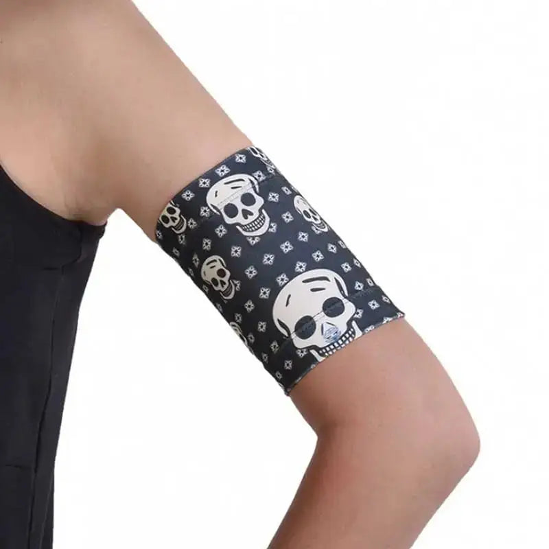 Trendy CGM arm band with skull design, securely holding a glucose sensor, suitable for sports and swimming.